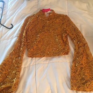 Mustard sequin crop top with flared sleeves.